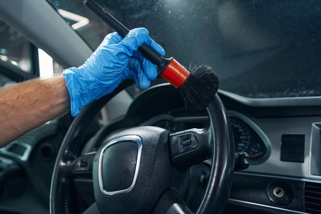 man-removing-dust-and-dirt-from-wheel-with-detaili-UBLNGNH.jpg